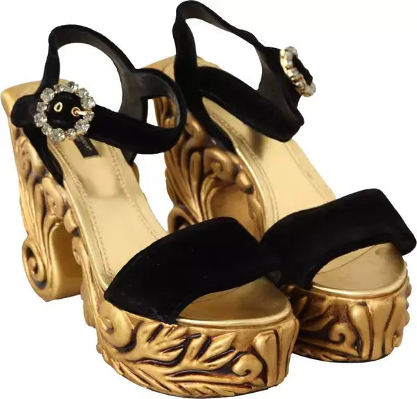 Gold platform sandals with black straps on a white background