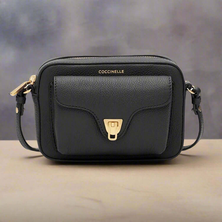Black handbag with gold accents on a white background