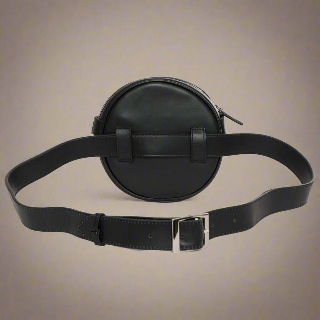 Black round leather bag with a belt and buckle on a white background