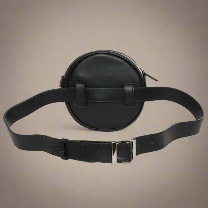 Black round leather bag with a belt and buckle on a white background