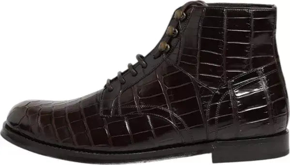 Dark brown crocodile-patterned leather boot on a white background