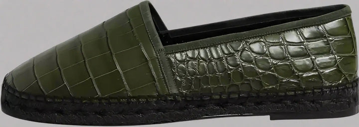 Green crocodile-patterned slip-on shoe on a white background