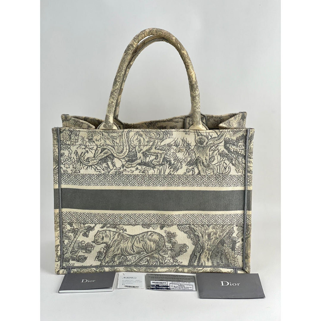 Designer handbag with intricate pattern and matching card holder on a white background