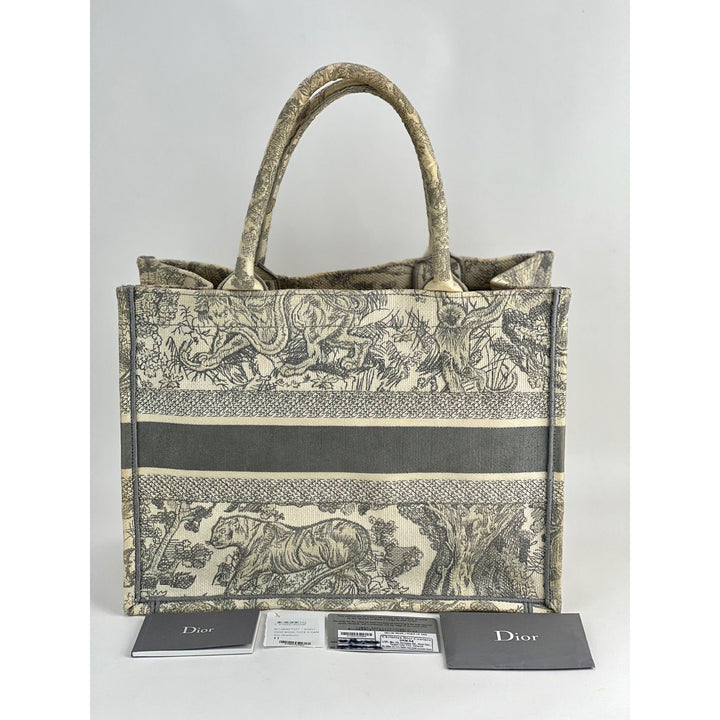 Designer handbag with intricate pattern and matching card holder on a white background