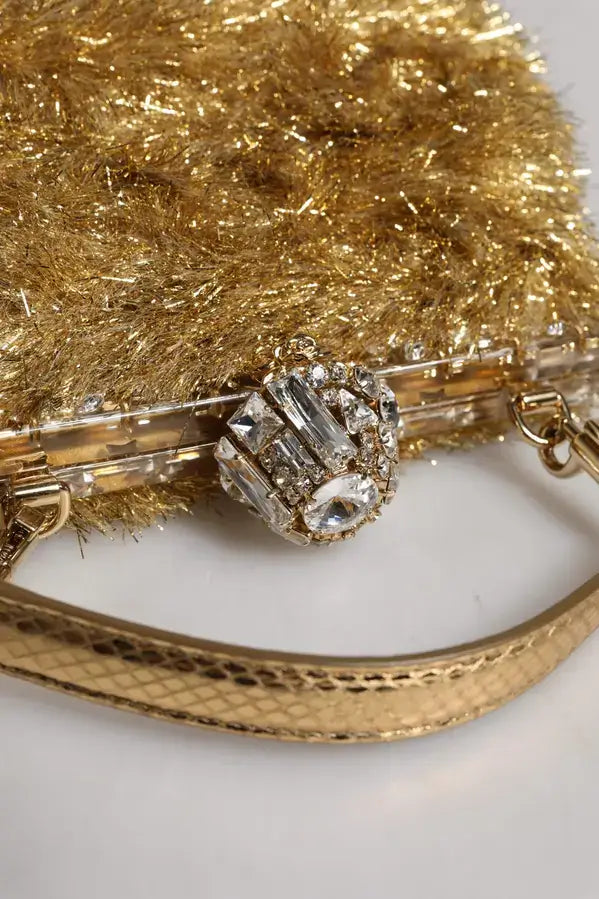 Gold clutch with gemstone detail on a white background