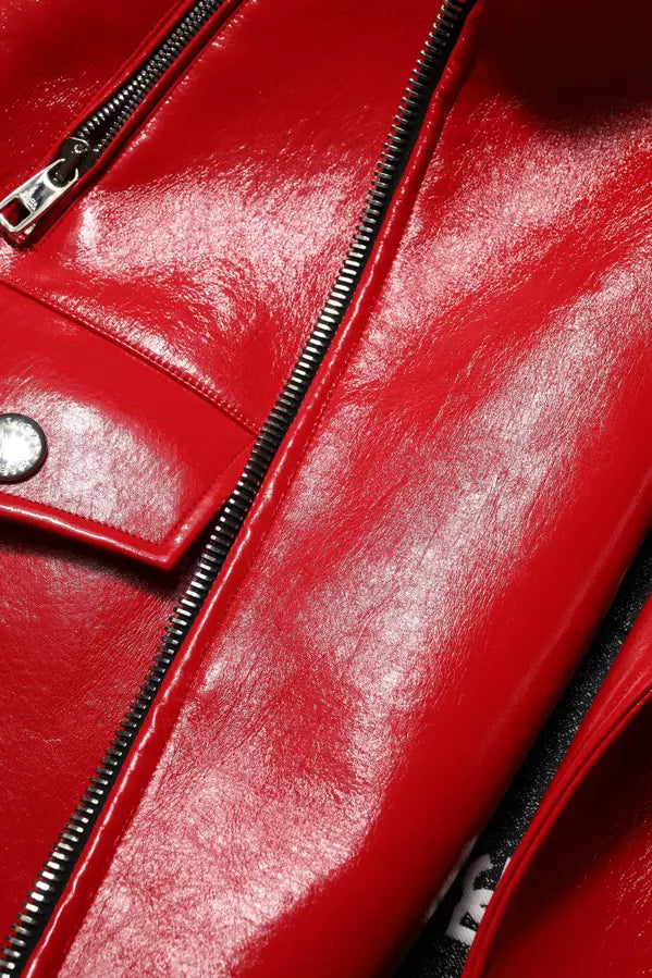 Close-up of a red leather jacket with a zipper