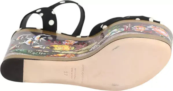 Sole of a sandal with floral design and brand name on a white background