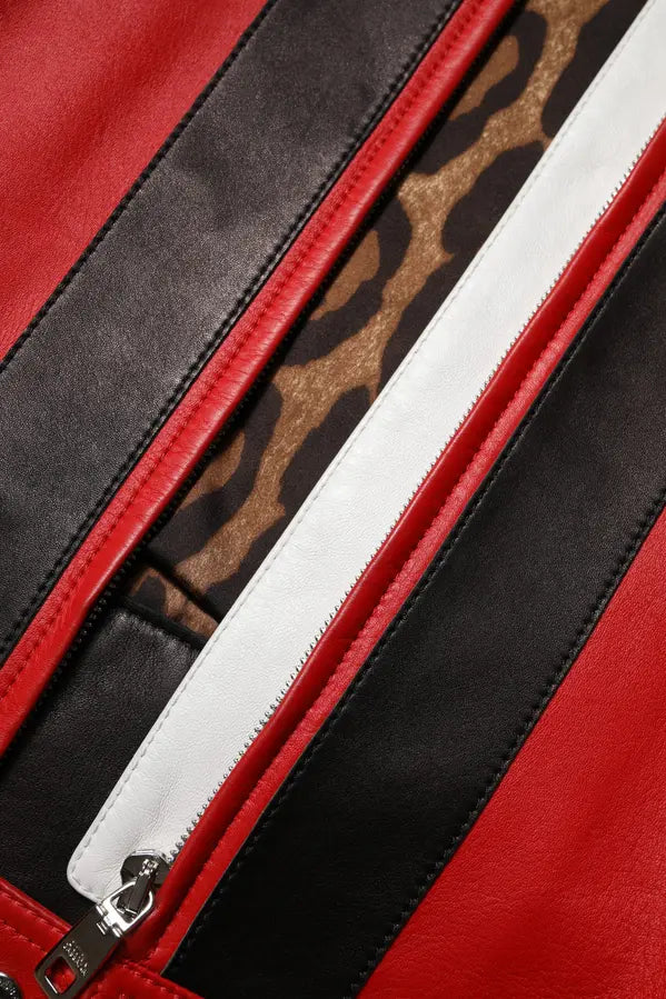Close-up of a red, black, and white patterned bag with a zipper.