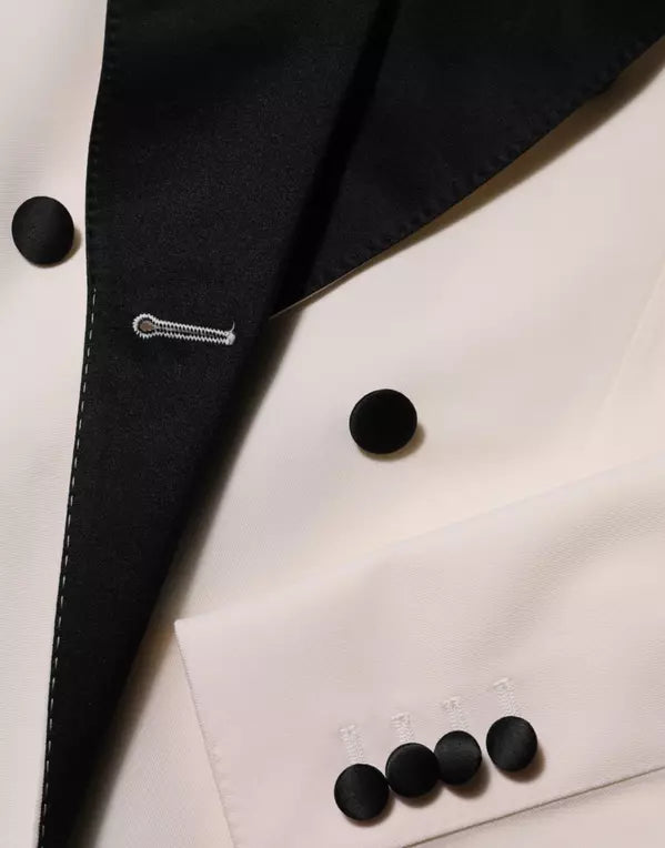 Close-up of a black button on a white fabric with a clear plastic display case.