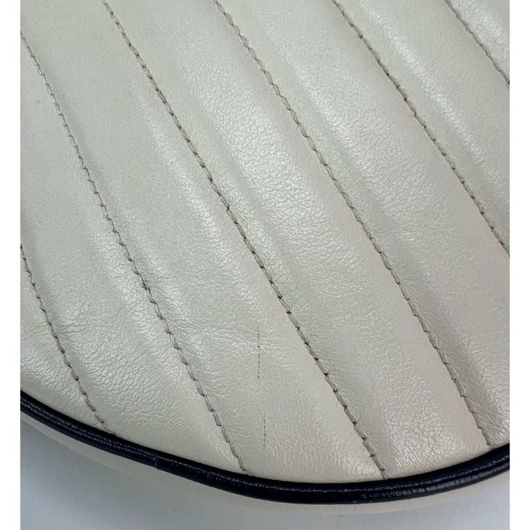 Close-up of a quilted leather saddle pad with visible stitching on a white background