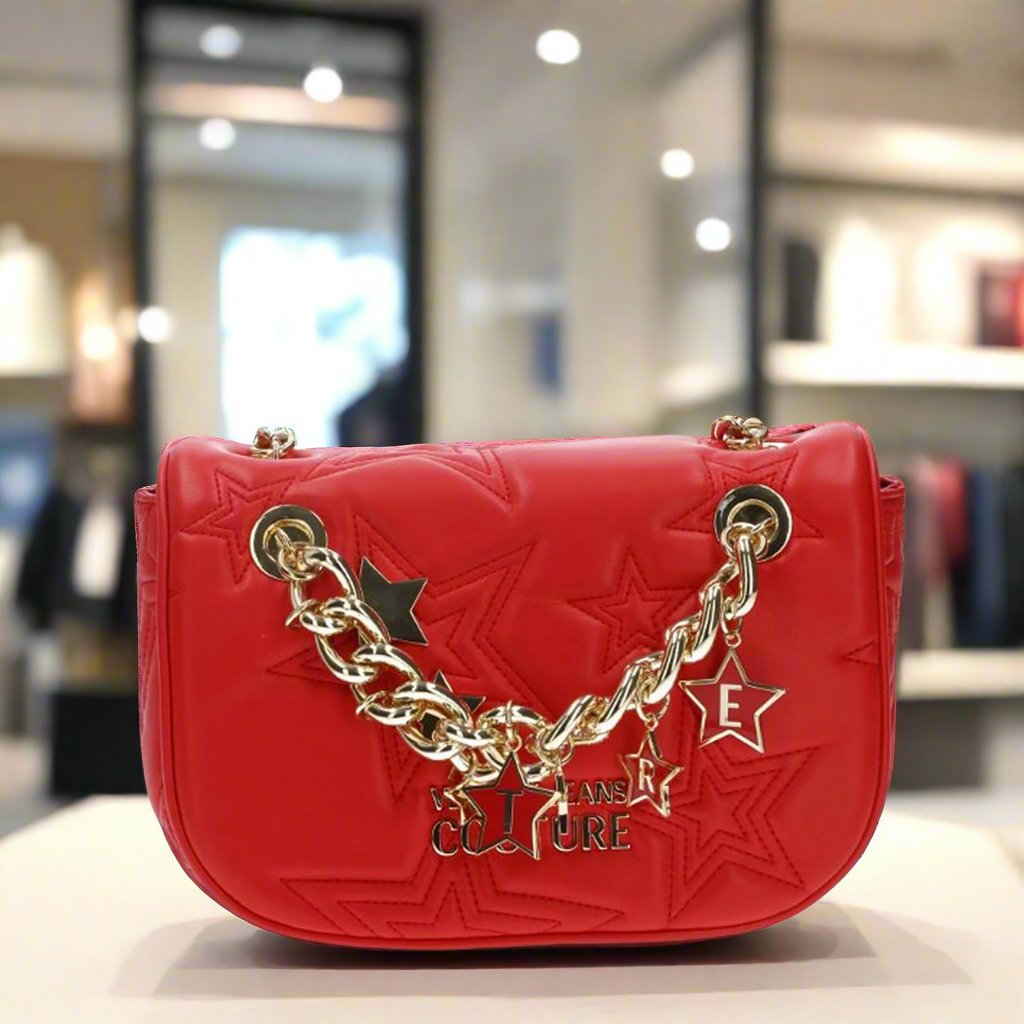 Versace Jeans Couture crossbody bag in red with gold chain, visible logo, and star details, a stylish synthetic leather handbag.