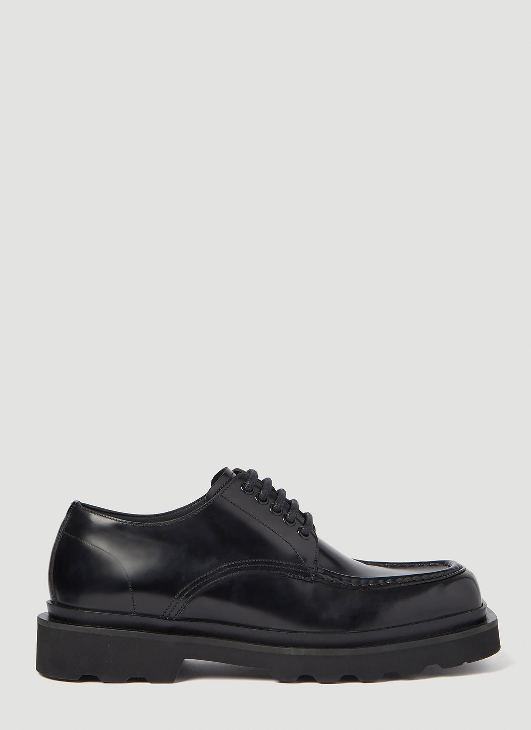 Black sneaker with white sole on a white background