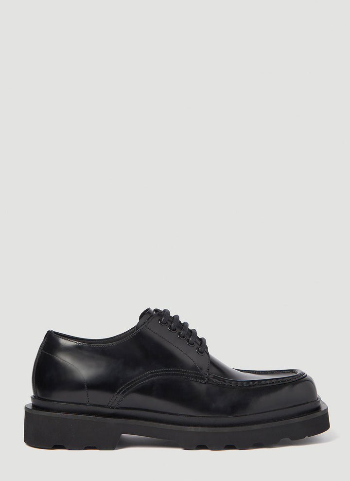 Black sneaker with white sole on a white background