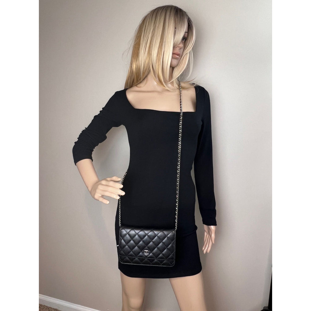 Chanel Quilted Caviar Calfskin Wallet on a Chain Clutch displayed on a mannequin wearing a black dress.