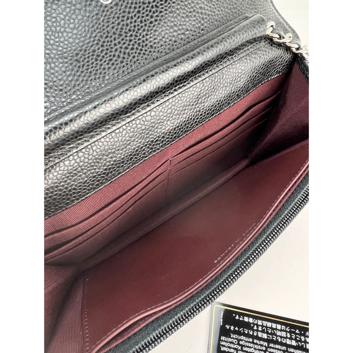 Interior view of Chanel Quilted Caviar Calfskin Wallet on a Chain Clutch showing burgundy fabric and leather.