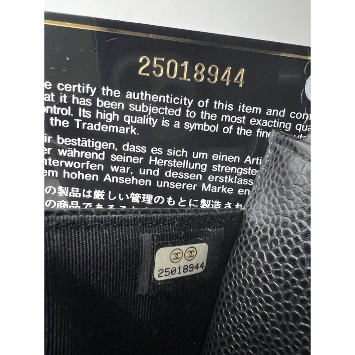 Chanel Quilted Caviar Calfskin Wallet on a Chain Clutch authenticity code 25018944 on black leather interior.