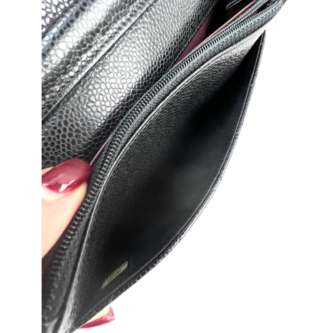 Interior view of Chanel Quilted Caviar Calfskin Wallet on a Chain Clutch showing black leather and burgundy fabric lining.