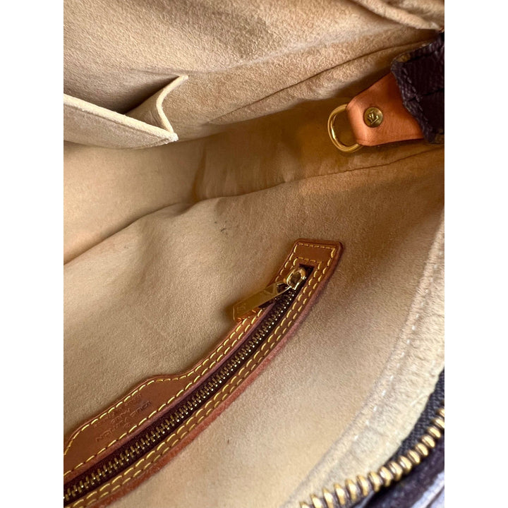 Interior view of LOUIS VUITTON Looping GM Monogram Shoulder Bag, showcasing lining and zipper compartment.