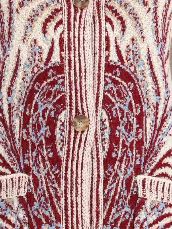 Close-up of a patterned fabric with red, beige, and blue colors.