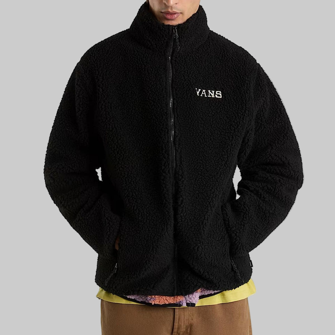 Black Vans jacket worn by a person on a white background