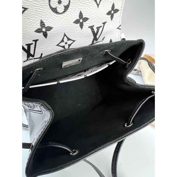 Inside view of LOUIS VUITTON Hot Springs Backpack White Monogram and Patent Leather showing luxury bag details.