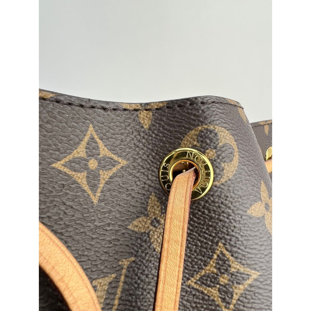 Close-up of LOUIS VUITTON Montsouris NM Monogram Backpack showcasing leather details and gold hardware, perfect for luxury bags.