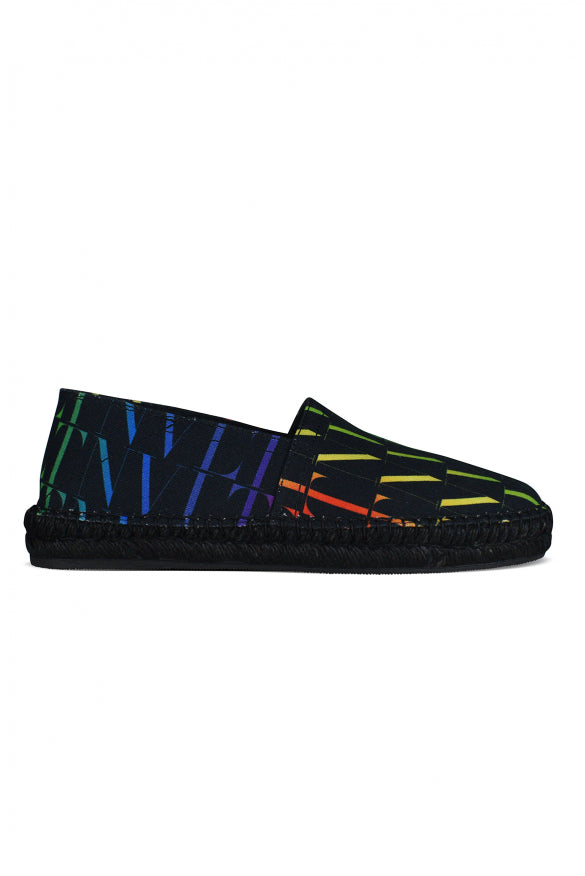 Black slip-on shoes with colorful abstract pattern on a white background