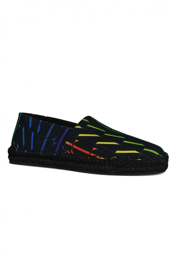 Black slip-on shoes with colorful geometric pattern on a white background