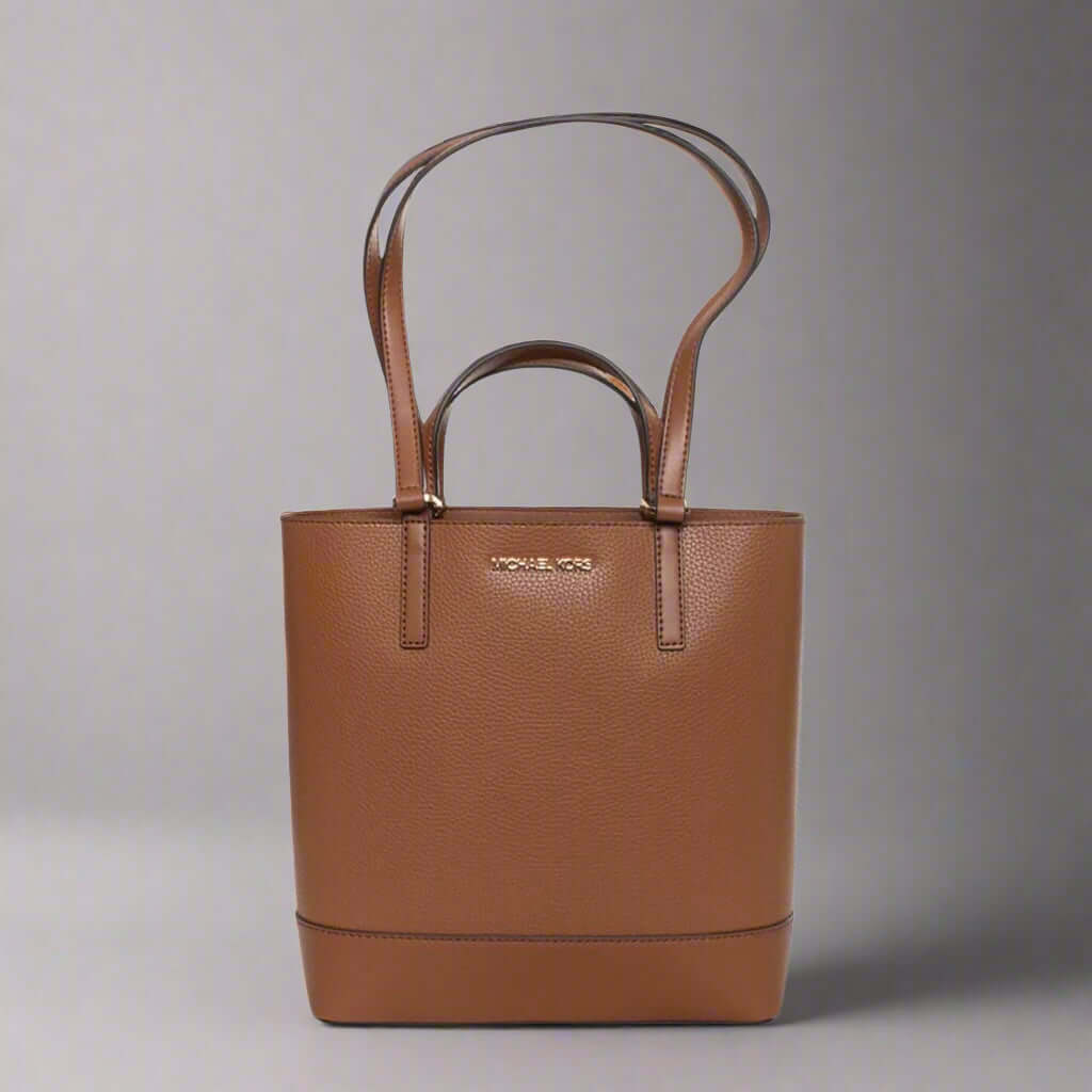 Brown handbag with 'Michael Kors' logo on a white background