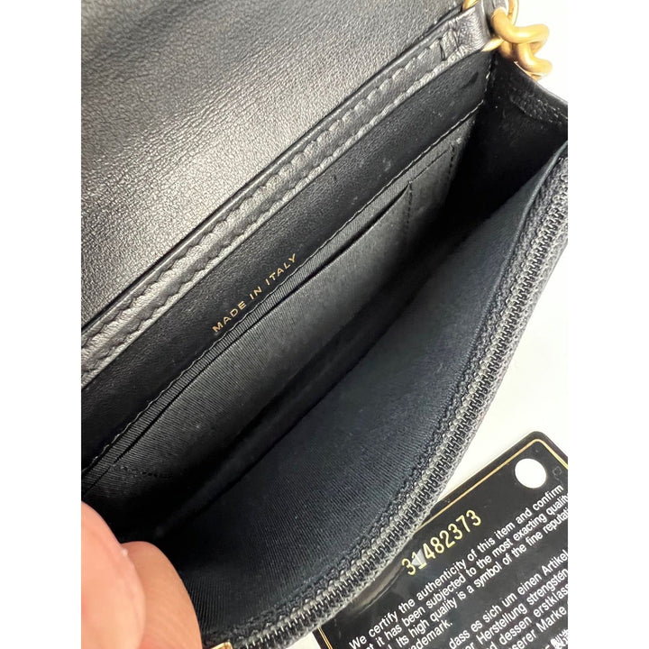 Interior view of Chanel Caviar Quilted Mini Boy Clutch Wallet on a Chain Black showing 'Made in Italy' inscription.