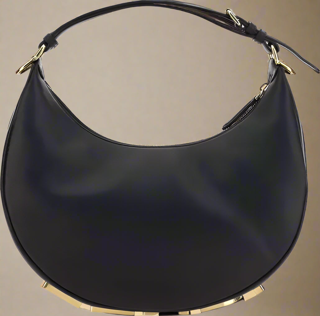 Black handbag with gold accents on a white background