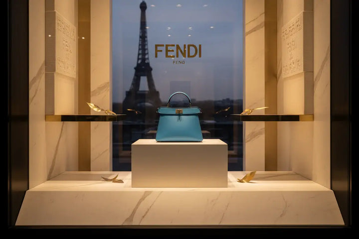 Blue handbag with a gold clasp on a white background