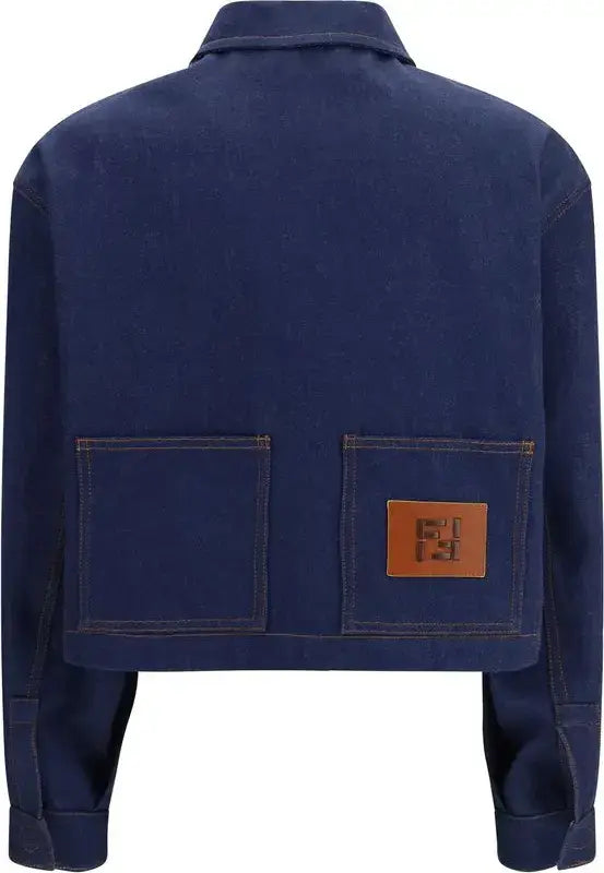 Blue denim jacket with a brown leather patch on a white background