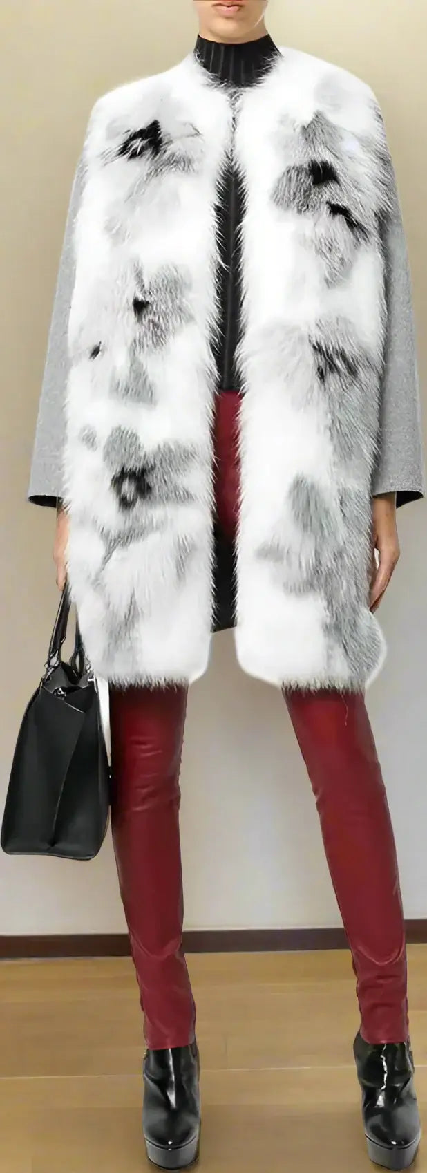 Person wearing a white fur coat with black abstract patterns, red pants, and black shoes.