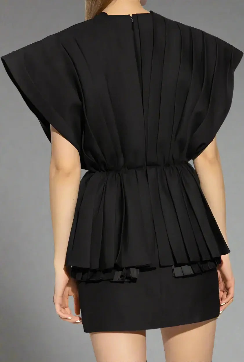 Black dress with ruffled layers on a white background