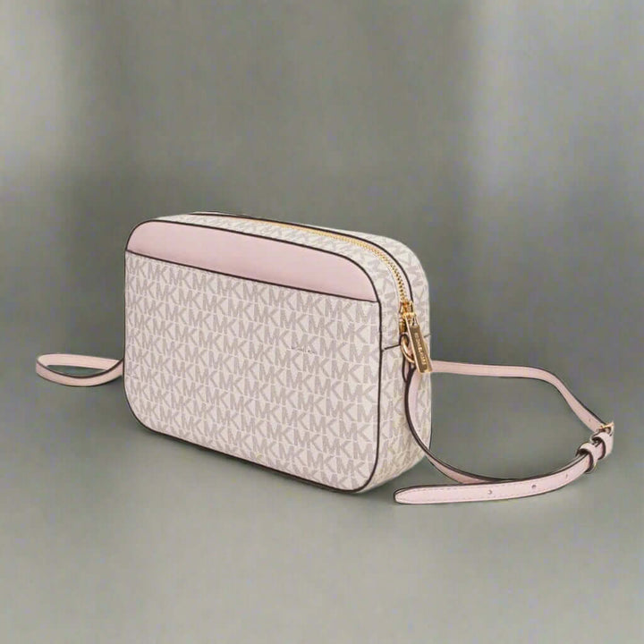 Crossbody bag with a patterned front and pink sides on a white background
