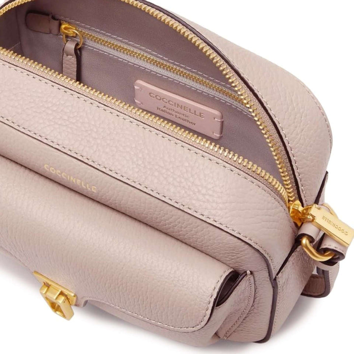 Beige handbag with gold accents and Coccinelle branding on a white background