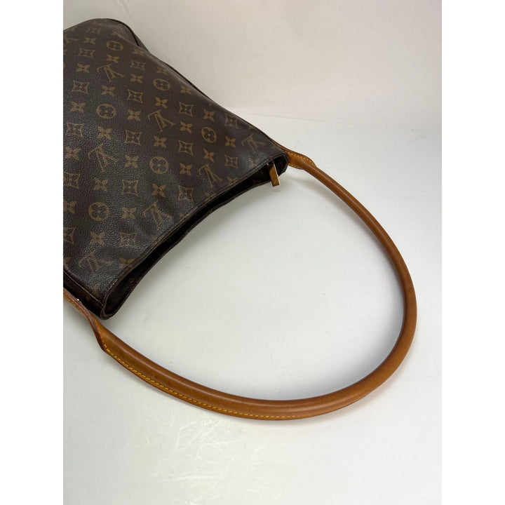 LOUIS VUITTON Looping GM Monogram Shoulder Bag showing a side view of the luxury bag's handle and monogram canvas.