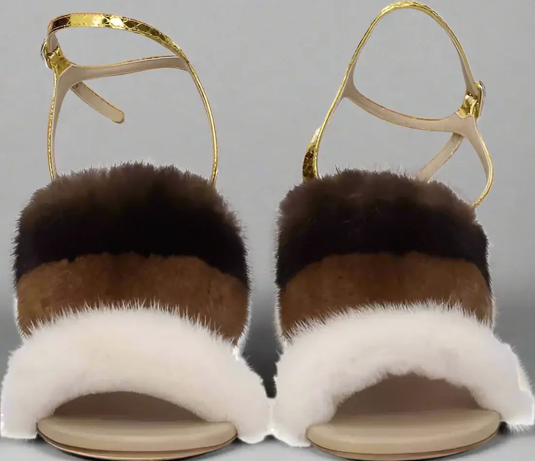 Pair of sandals with fur straps on a white background
