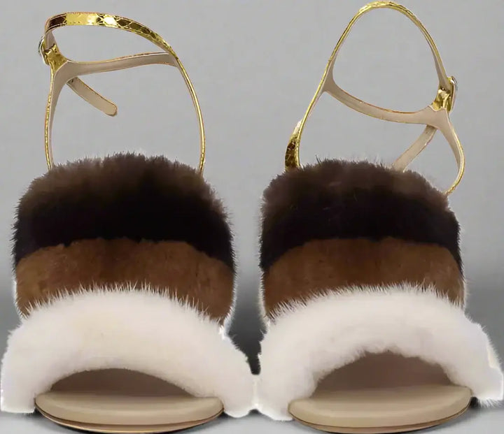 Pair of sandals with fur straps on a white background