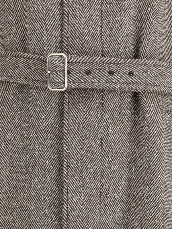 Close-up of a textured fabric with a belt and buckle detail