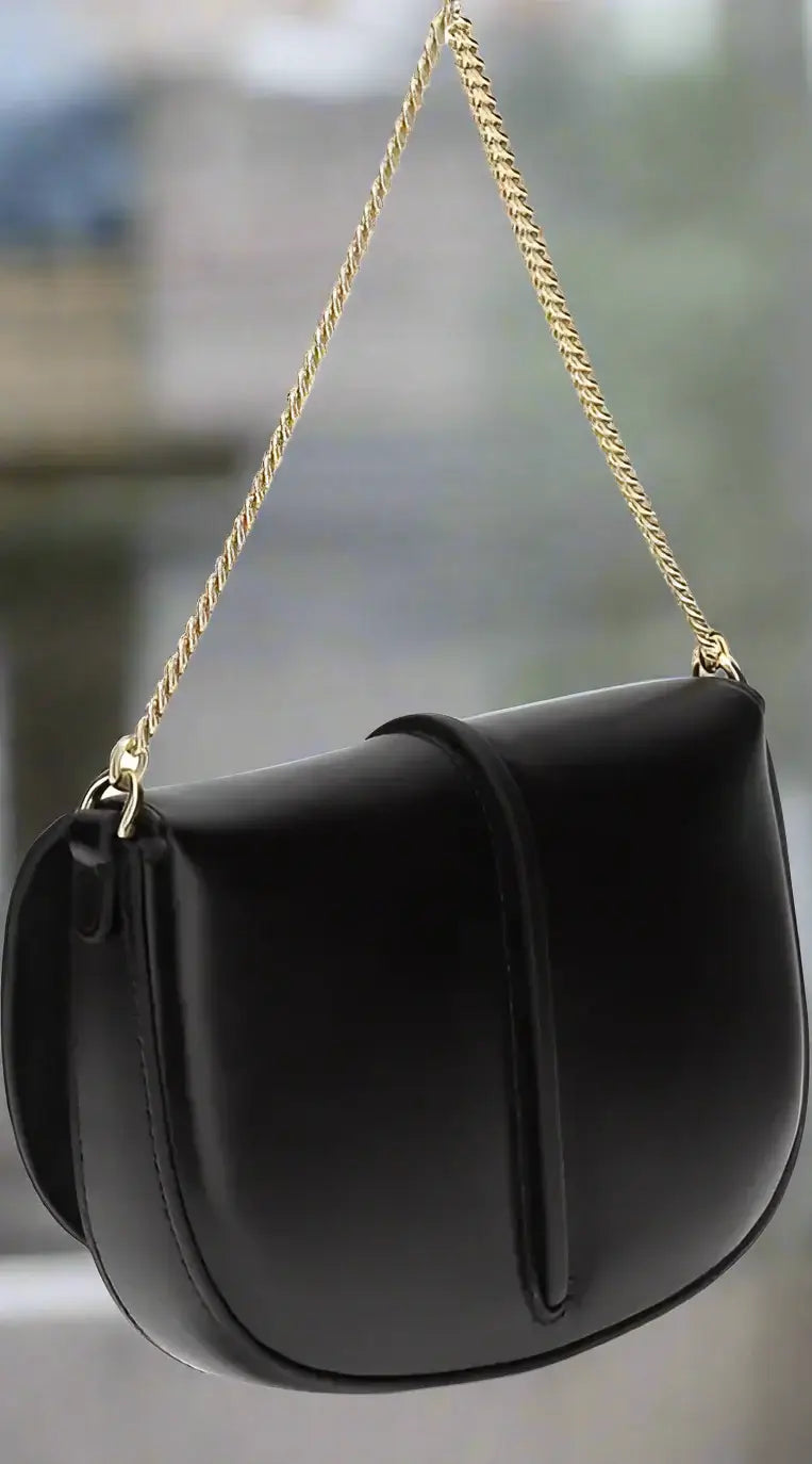 Black handbag with a gold chain strap on a white background