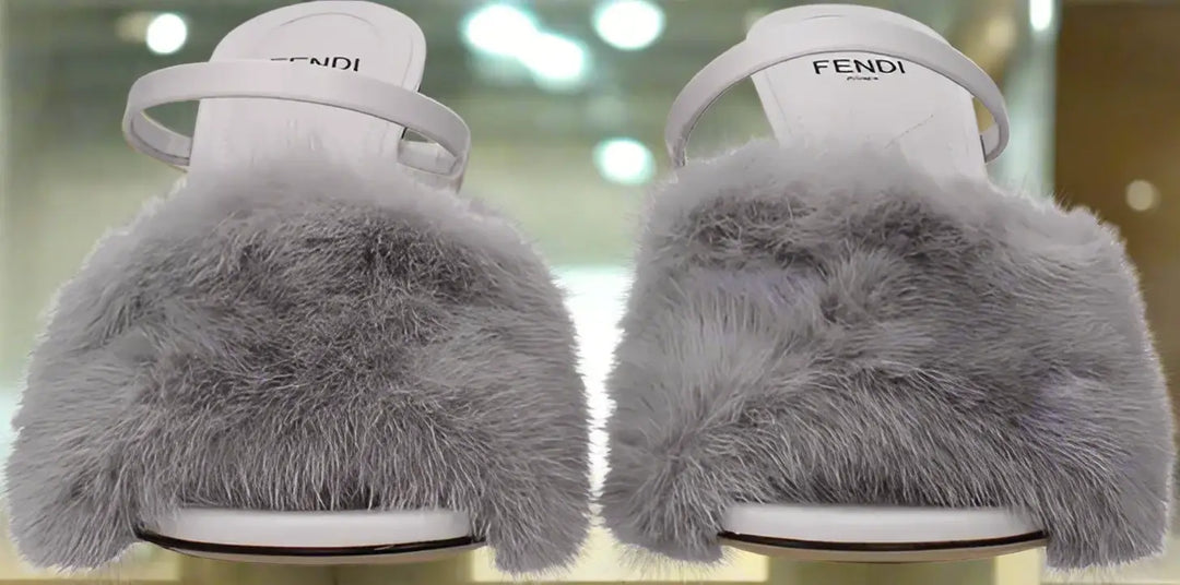 Pair of Fendi shoes with fluffy gray sole on a white background