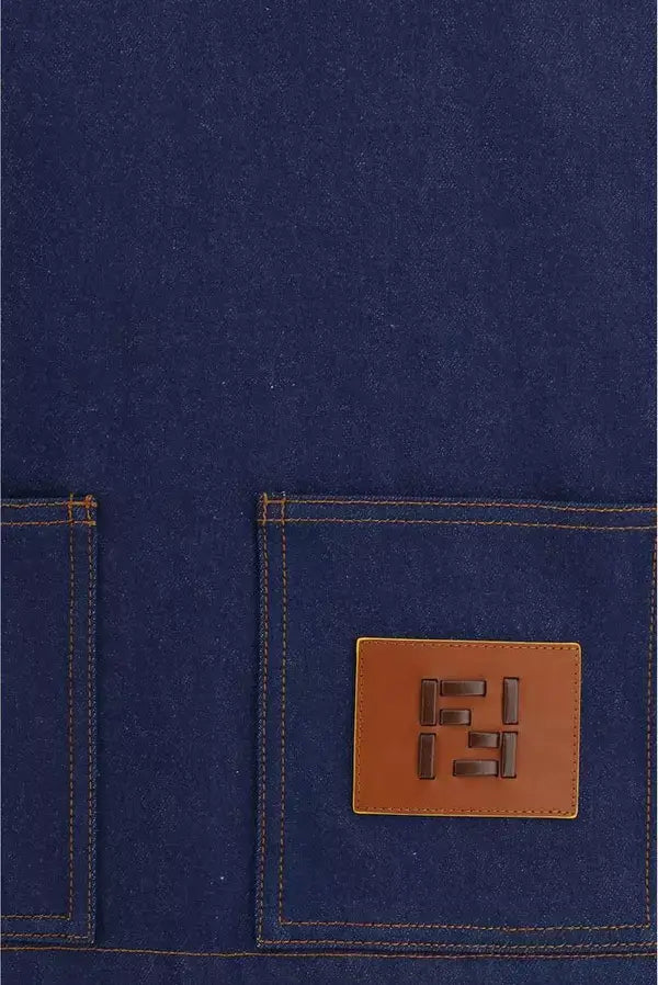 Close-up of a blue fabric with a brown leather patch featuring a logo.