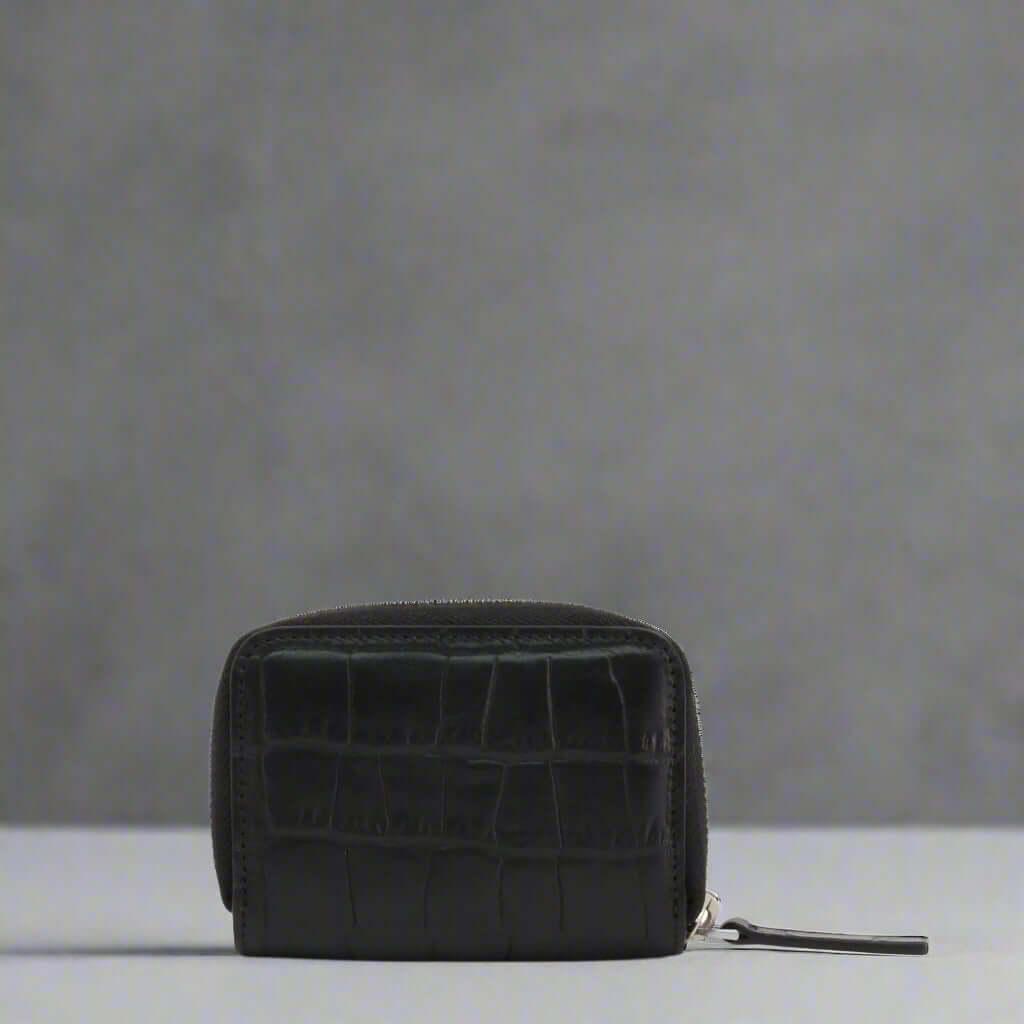 Black crocodile-patterned wallet on a white background