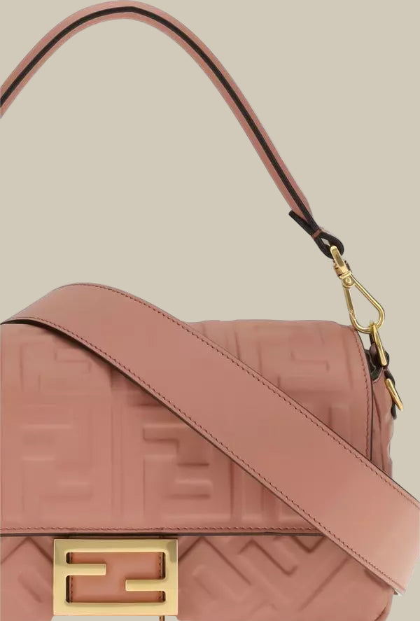 Pink handbag with gold logo on a white background