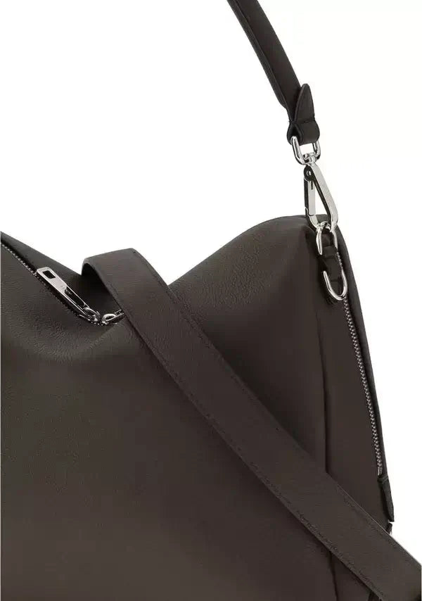 Close-up of a dark brown leather bag with a shoulder strap and silver zipper.