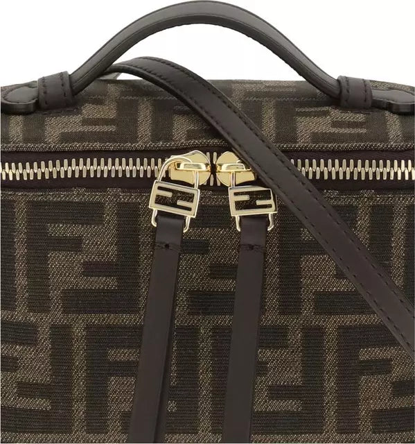 Designer handbag with gold hardware and monogram pattern on a white background