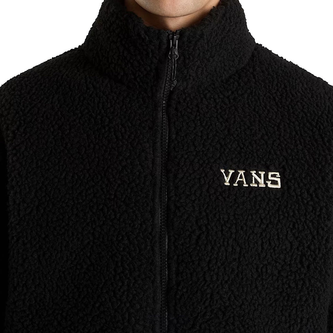 Black fleece jacket with Vans logo on a white background