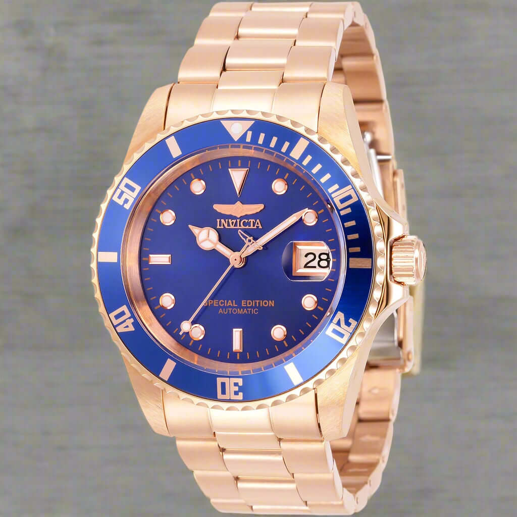 INVICTA Pro Diver men's watch with stainless steel band INVICTA black graphic t-shirt with logo front Gold-tone INVICTA chronograph wristwatch close-up INVICTA men's button-down shirt with embroidered detail INVICTA oversized sport watch and branded appar